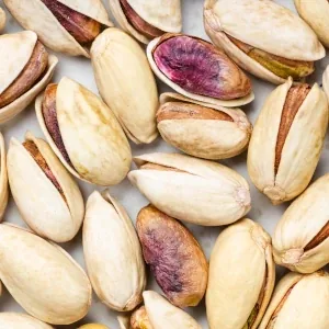 Shelled and in-shell pistachio nuts shown close up